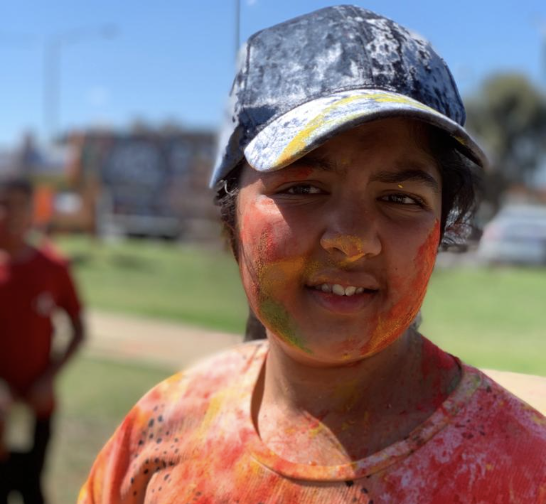 Trisha wears baseball cap and looks at camera